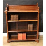 An Aesthetic Movement style walnut and mahogany open bookcase, the four shelves flanked by