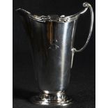 An Art Deco silver cream jug, shaped geometric rim, stepped circular foot, 12cm high, William Hutton