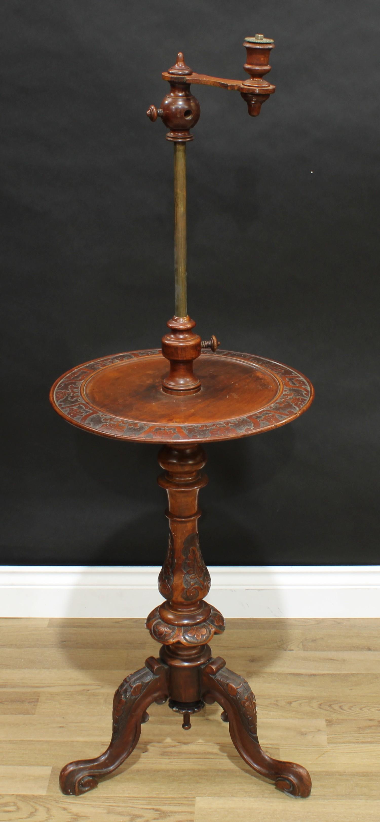 A Victorian walnut combination table and adjustable lamp, the sconce set on telescopic pillar,
