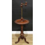 A Victorian walnut combination table and adjustable lamp, the sconce set on telescopic pillar,