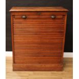 An early 20th century oak tambour-front filing cabinet, in the manner of Globe Wernicke, retractable
