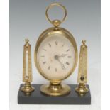 A late 19th century gilt brass desk top timepiece, the 6cm oval clock dial inscribed with Roman