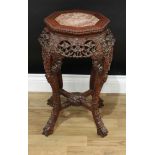 A Chinese hardwood octagonal jardiniere stand, beaded top with inset soapstone panel above a