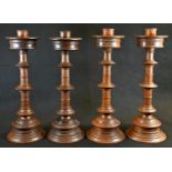 A set of four Gothic Revival turned oak altar candlesticks, knopped pillars, circular bases, 40cm