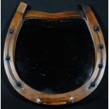 An early 20th century oak novelty equestrian mirror, as a horseshoe, 28cm wide