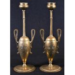 A pair of 19th century Grecian Revival gilt bronze candlesticks, lofty sconces, loop handles,