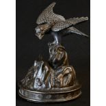 Japanese School (Meiji period), a dark patinated bronze, of an eagle perched on a rocky outcrop,