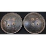 A pair of 19th century Indian Mughal circular hide dhal shields, each typically mounted with four