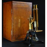 A late 19th/early 20th century patinated and lacquered brass monocular microscope, by Henry