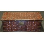 An Islamic hardwood rectangular chest, hinged cover carved with rows of stylized lotus, 'fleur-de-