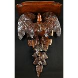 A 19th century oak wall bracket, carved as a pelican in her piety, shaped plateau, 52cm high, 35cm