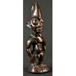 Tribal Art - a Yoruba Ibeji figure, standing with arms to the side, adorned with a beadwork