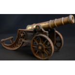 A bronze and cast iron model signal cannon, the carriage pierced with roundels and guilloche, 48cm
