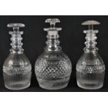 A pair of early 19th century mallet-shaped cut glass decanters, faceted shoulders above graduating