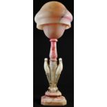 A French Art Deco period rouge-blushed alabaster table lamp, domed shade, the pillar carved as a