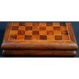 A 19th century yew travelling chess board, the parquetry field outlined with boxwood stringing,