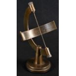 A brass desk top armillary sundial, hemisphere scale engraved with Roman numerals, 19.5cm high