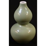 A Chinese celadon double-gourd vase, 12cm high, blue square seal mark