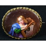 A Continental porcelain oval plaque, painted with a portrait miniature of a lady with a harp, 6cm