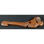 Tribal Art - a Polynesian hardwood axe, carved as a stylised figure, the stone head bound with cord,