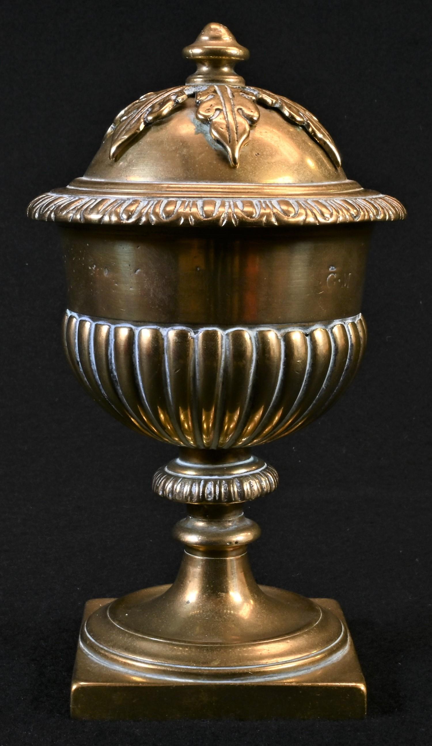 A 19th century polished bronze half-fluted urn and cover, knop finial with acanthus boss, square