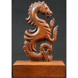 An oak cresting or appliqué, carved as a sea horse, rectangular display plinth, 27cm high