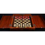 An Edwardian mahogany travelling chess set, folding diptych board, 21cm wide, c.1910