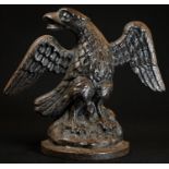 A 19th century cast iron door stop, as a spread eagle, 21cm wide