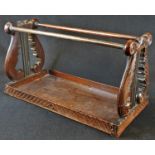 A 19th century Anglo-Indian hardwood book carrier, lyre-shaped end supports carved with scrolling