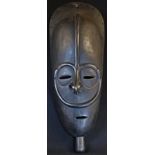 Tribal Art - a large African mask, domed forehead with central ridge, 68cm long