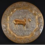 A Middle Eastern brass circular charger, chased with a stylised ox and devices, the ground and