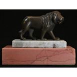 A Grand Tour type bronze mounted desk weight, cast as a lion, stepped white and rose marble base,