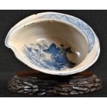 A Japanese porcelain brush washer, as an abalone shell, painted in tones of underglaze blue with a