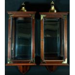 A pair of George III style brass mounted mahogany candle lantern cabinets, ogee domed chimneys,