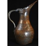 A 19th century Persian tinned copper baluster ewer, typically chased with deer, birds, and flowering