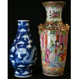 A small Chinese baluster vase, painted in underglaze blue with ferocious dragons pursuing the