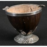 A 19th century coconut cup, the silver plated base cast with lotus, the rim applied with vine