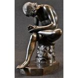 Italian Grand Tour School (19th century), a dark patinated library bronze, Spinario or Boy with