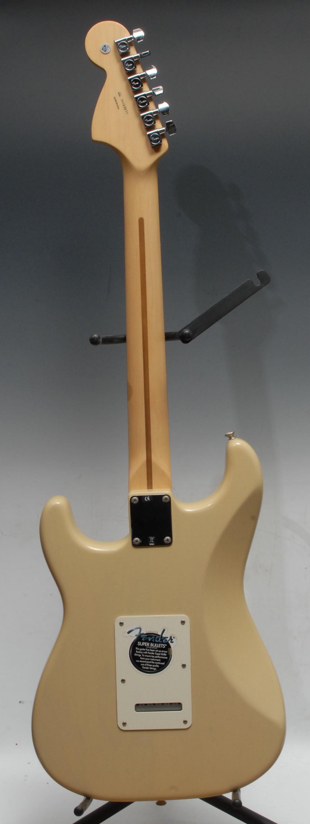 A Fender Stratocaster electric guitar, USA honey blonde, maple neck, rosewood finger board. Serial - Image 7 of 8