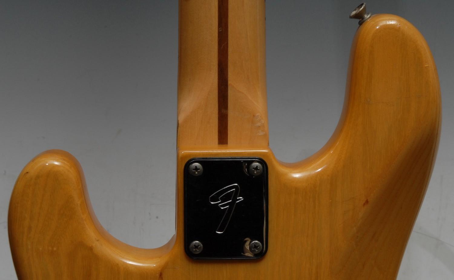 A Fender Precision electric bass guitar USA, natural wood body, maple neck, black pickguard. - Image 12 of 16