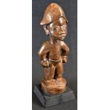 Tribal Art - a Yoruba figure, he stands, with each hand full, 33cm high, Nigeria, ebonised