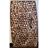 Tribal Art - an Asmat rectangular panel, carved and decorated in earth and white pigments with