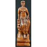 A North European oak carving, of a lady, seated upon rocks, 25.5cm high, 19th century