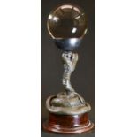 A dark patinated bronze and clear glass 'crystal ball', cast as a coiled snake, plinth base, 32cm