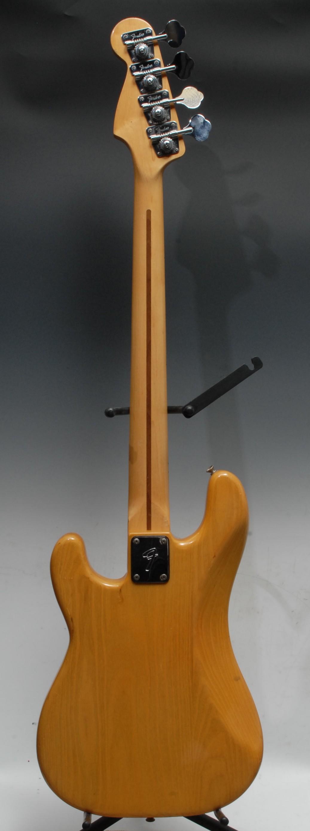 A Fender Precision electric bass guitar USA, natural wood body, maple neck, black pickguard. - Image 9 of 16