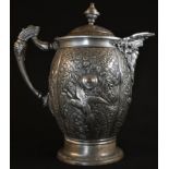 A 19th century pewter baluster flagon, elaborately cast in relief with parrots in reserves of