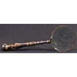 A brass connoisseur's lens, the magnifying glass 10cm diam, 'turned' handle, 29.5cm long