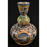 A maiolica gourd shaped vase, painted in the istoriato manner with landscape vignettes, herms and