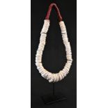Tribal Art - a large Papua New Guinea conus shell currency necklace, 37cm drop
