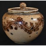 A late 19th century brown and buff salt glazed stoneware jar and cover, incised with scrolling